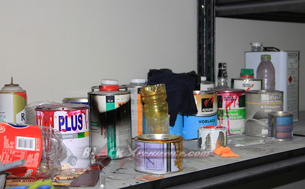 Peralatan dan kaleng-kaleng cat di ruang pengecatan bengkel Exotic Bike